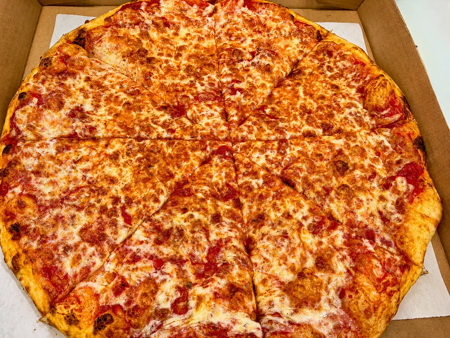 Fresh cheese pizza in a box